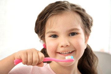 Cute little girl with toothbrush, close up