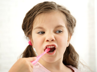 Cute girl with toothbrush isolated on white