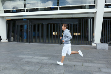 Young man running on the street