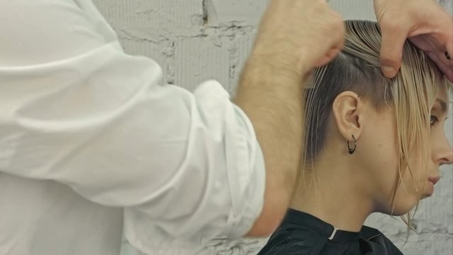 Hairdresser girl combing her hair