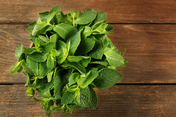 Fresh bunch of mint on wooden table