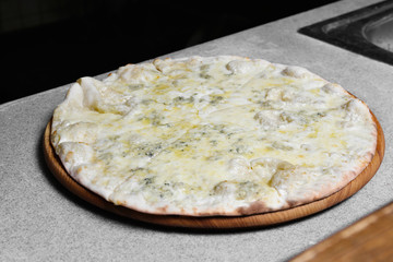 Tasty pizza on wooden board