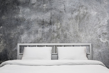 loft bedroom with gray cement wall