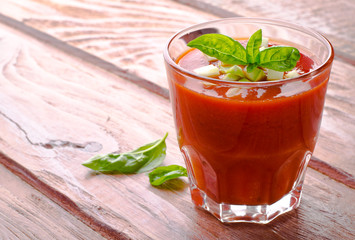 Tomato gazpacho in a glass with basil ang zucchini