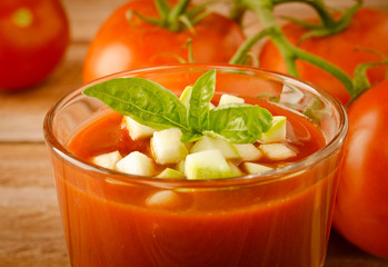 Tomato gazpacho in a glass with basil ang zucchini