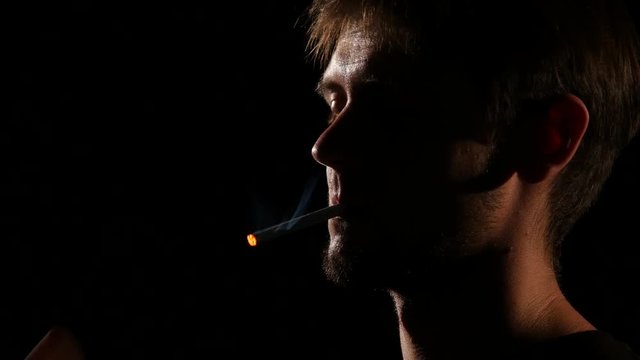 Man mouth smoking cigarette. Backlight. Close up
