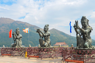 HONG KONG,HONG KONG - December 8, 2013:Three Buddhistic statues ("The Offering of the Six Devas") making offerings to the Tian Tan Buddha (or Big Buddha) in Ngong Ping, Lantau Island, Hong Kong