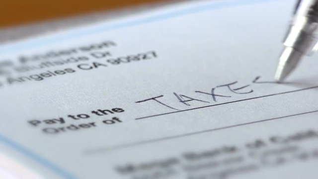 Macro shot of a check being filled out.