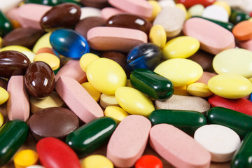 Heap of colorful medical pills and capsules, health care concept