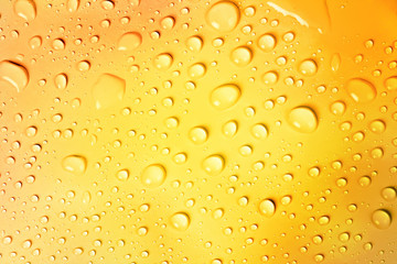 water drop on yellow gold background