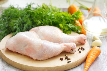 Raw chicken legs with vegetables ready for cooking