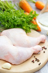 Raw chicken legs with vegetables ready for cooking