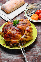 Roasted chicken on wooden plate