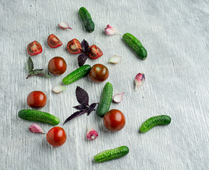 Tomatoes with basil on wooden table background. Food composition. Top view