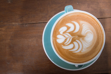 close up a cup of coffee on wood back