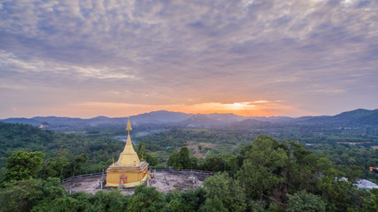 Big Buddha statue and golden pagoda on hilltop this temple have several amazing building and famous in thailand.this temple is beside national park. the middle part of Thailand