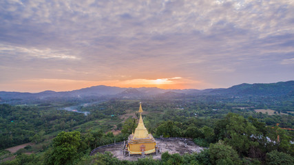 Big Buddha statue and golden pagoda on hilltop this temple have several amazing building and famous in thailand.this temple is beside national park. the middle part of Thailand