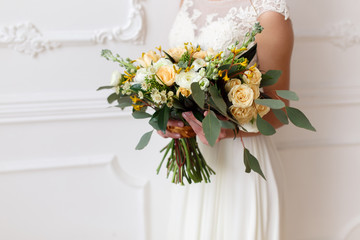 bride holding a bouquet of flowers in a rustic style, wedding bouquet