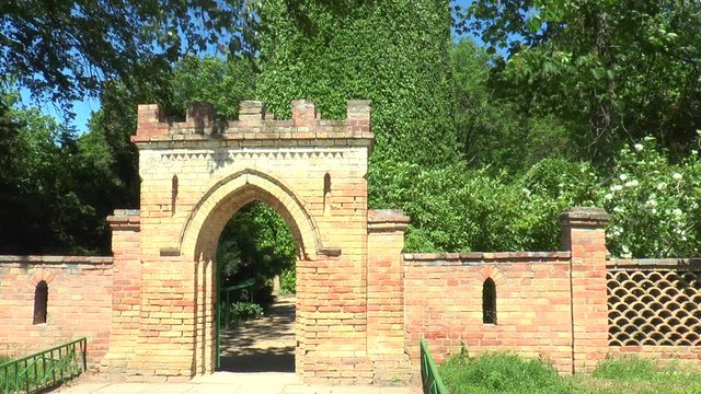 Entrance to the park. In the background you can see the tower overgrown with wild grapes