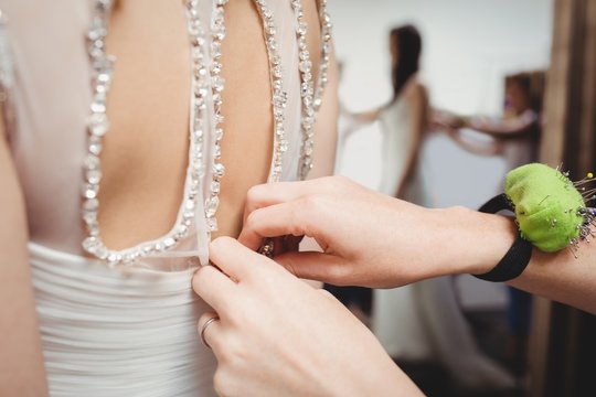 Woman trying on wedding dress