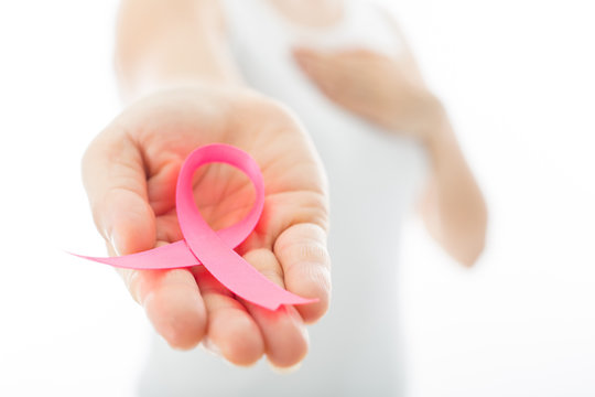 Pink Breast cancer awareness ribbon holding by woman