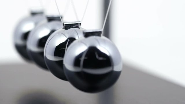 Slow motion shot of a Newton's Cradle.