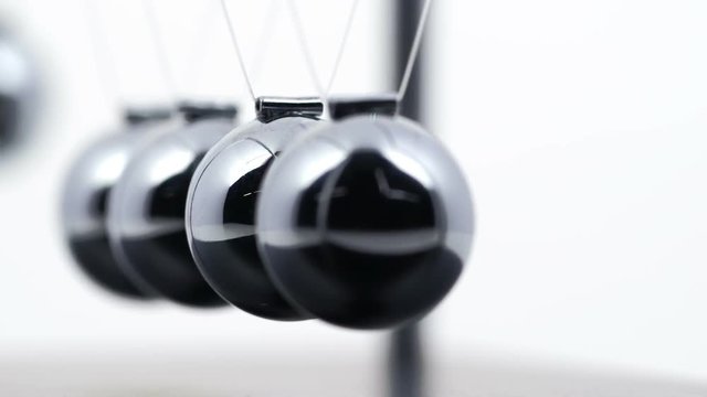 Slow motion shot of a Newton's Cradle.