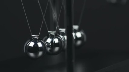 Slow motion shot of a Newton's Cradle. - Powered by Adobe