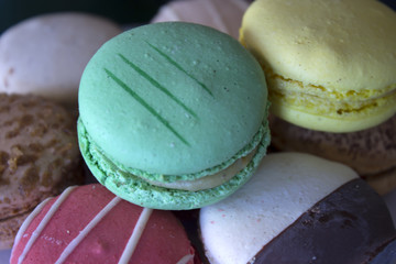 This is a photograph of Chocolate,Vanilla,Red Velvet,lemon,lime,passion fruit and coffe flavored Macarons