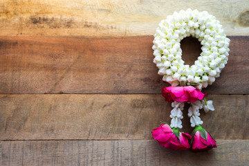 Thai traditional jasmine garland On wooden background symbol of Mother's day in thailand, to offer...