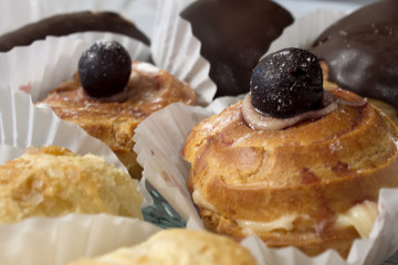 This is a photograph of Eclairs and sweets filled with custard and cream