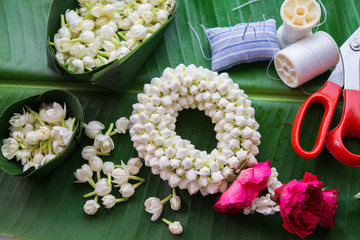 Fototapeta na wymiar Set of tool for making Thai traditional jasmine garland. Symbol of Mother's day in Thailand.
