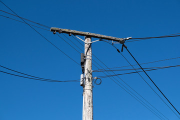 Rotting old wooden telegraph post, or telephone or power pole. Photographed in Whangarei, Northland, New Zealand, NZ.