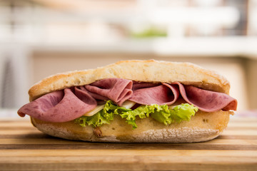 Ham sandwich on a wooden surface