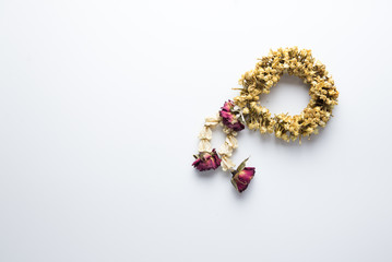 Dried Thai garland on a white background. Dried flowers, For Thai people - garland is a symbol of a...