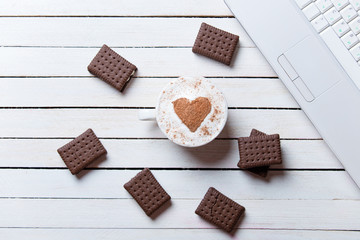 cup of coffee, cookies and laptop