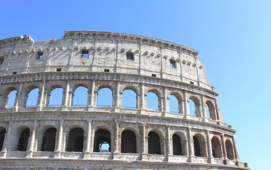 Fototapeta na wymiar Great Colosseum in Rome, Italy, Europe. Roman Coliseum close-up with clear blue sky.