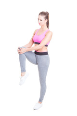 Woman wearing sports wear stretching legs before workout