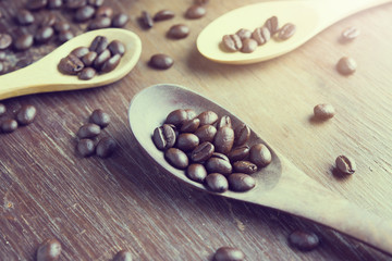 coffee beans in wooden spoon on the table