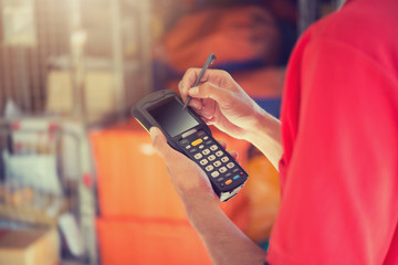 Worker Checking and Scanning Package by tablet handheld In Warehouse.