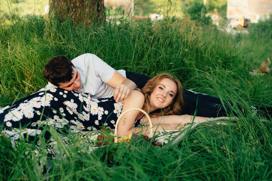 Lovers On A Picnic In The Summer Under A Tree