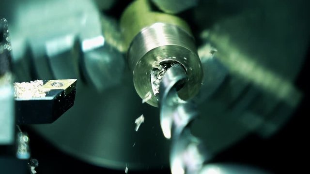 Metal drilling, super slow motion. Machining brass piece 250 fps close up shot