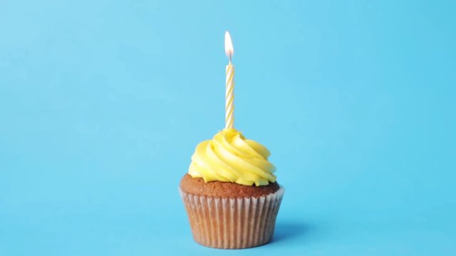 birthday cupcake with one burning candle