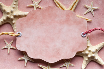 Paper label and starfish on paper background