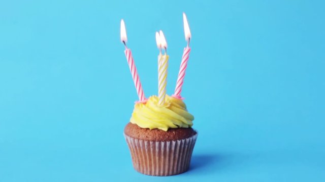 birthday cupcake with four burning candles