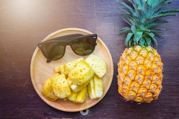 Pineapple and sunglasses - Summer time vacation holiday healthy concept .