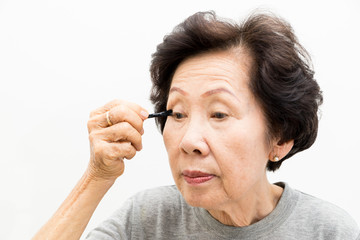 old woman applying make up,asian people, asian women