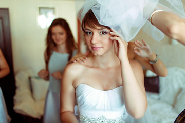 Pretty bride stands thoughtful during wedding preparations