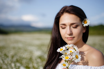 Beautiful woman on a flower granden enjoying her time outdoors