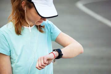 Obraz na płótnie Canvas Female runner looking at her sport watch.